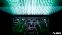 A man using a computer keyboard to enter data in Warsaw, Poland.