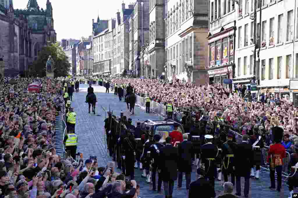 The Procession of Queen Elizabeth's coffin from the Palace of Holyroodhouse to St. Giles' Cathedral moves along the Royal Mile in Edinburgh, Scotland, Sept. 12, 2022.
