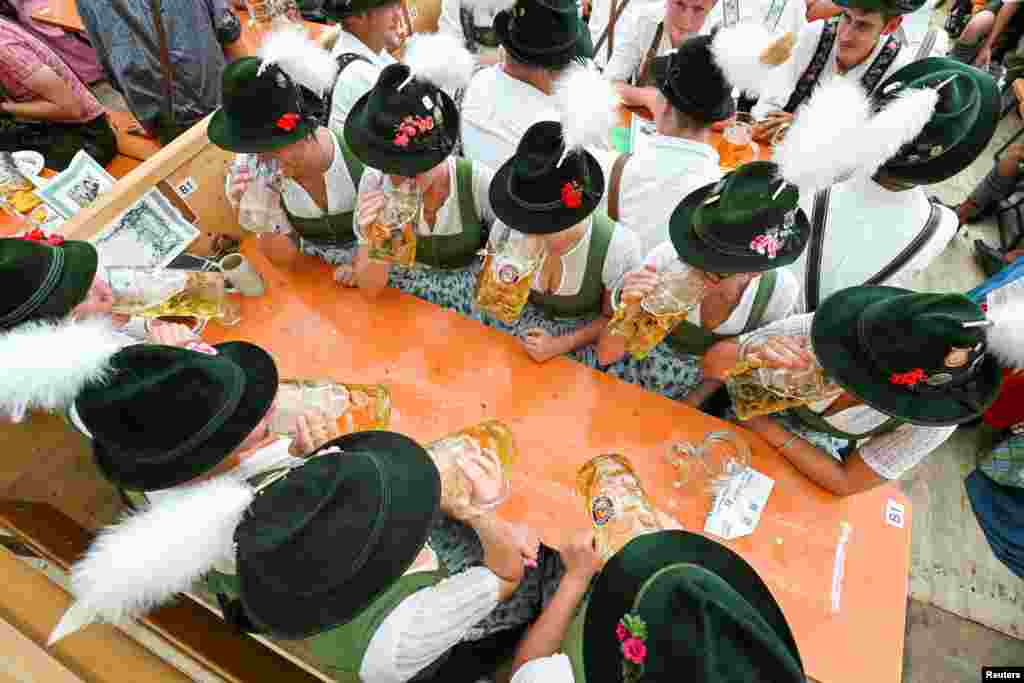 Visitors celebrate the world's largest beer festival, the 188th Oktoberfest, in Munich, Germany.