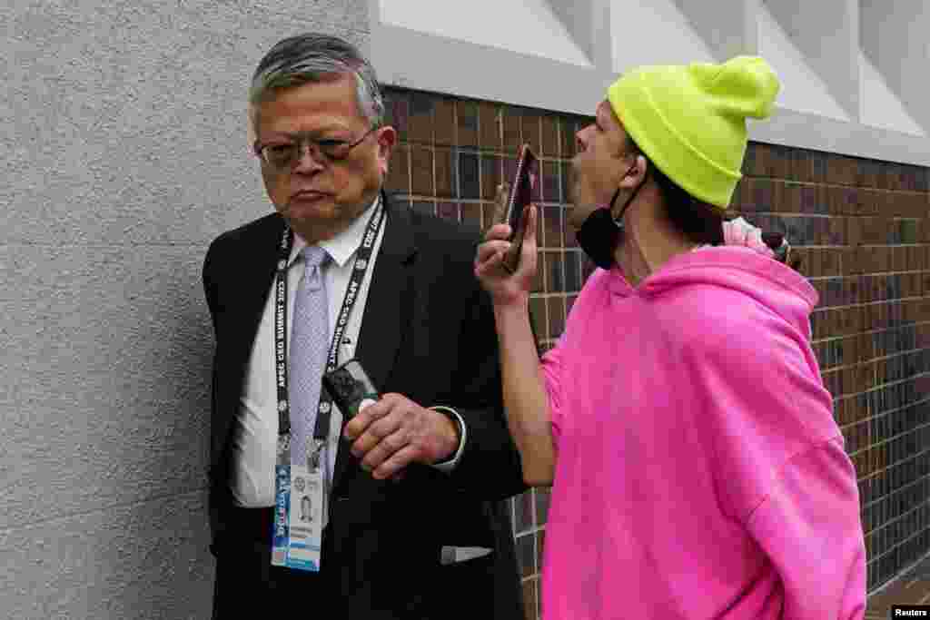 A protester taunts an attendee of the Asia-Pacific Economic Cooperation (APEC) CEO Summit during a rally in opposition to the summit in San Francisco, California.