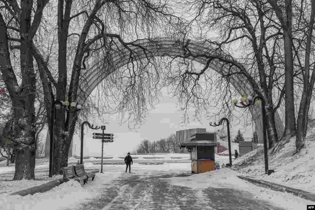 A person walks in the snow in a park in downtown Kyiv amid the Russian invasion of Ukraine.