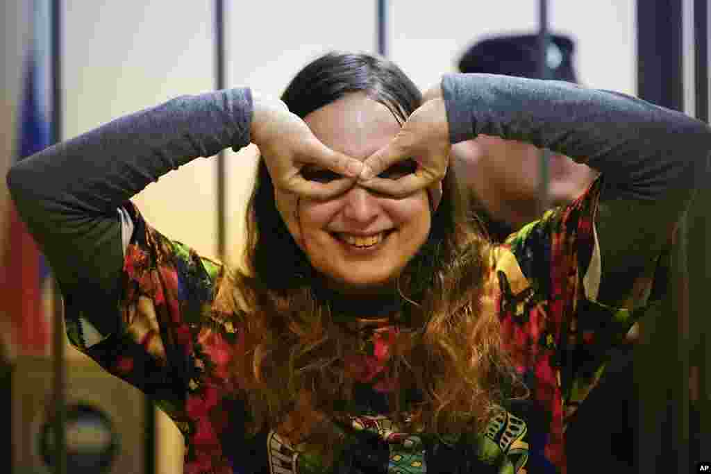 Sasha Skochilenko, a 33-year-old artist and musician, plays while standing behind bars in the court room as she waits for a hearing in the Vasileostrovsky district court in St. Petersburg, Russia. Skochilenko is charged with spreading "fakes" about the Russian military after she replaced four small price tags in a St. Petersburg supermarket with anti-war slogans. The prosecution asked to sentence her to 8 years in prison. 