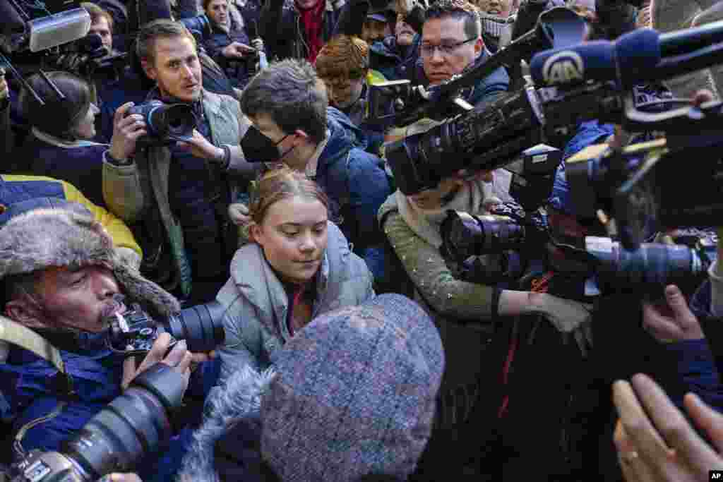 Climate activist Greta Thumberg, center, arrives at the Westminster Magistrates Court in London. She was charged with a public order offence after she was arrested while taking part in a protest against a conference in London described as "the Oscars of oil."