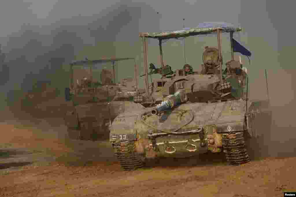A convoy of Israeli tanks maneuvers near Israel&#39;s border with Gaza, amid the ongoing conflict between Israel and the Palestinian Islamist group Hamas, in Israel.
