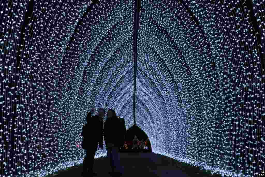People walk through the festive light trail at The Royal Botanic Gardens, Kew, in London, Nov. 14, 2023.