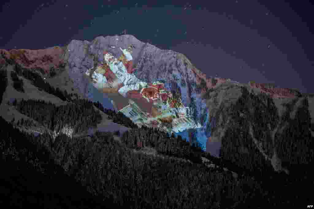 A photograph taken from Les Avants, above Montreux shows the 2,042 meters high Rochers-de-Naye alpine mountain illuminated with a giant Santa during a show by Swiss light artist Gerry Hofstetter to promote a Christmas Market.