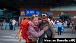 Norwegian climber Kristin Harila, 37, right, and her guide Tenjen Sherpa pose for a photograph in Kathmandu, Nepal, Tuesday, June 6, 2023. The Norwegian who is aiming to be the fastest climber to scale all the world's 14 highest mountains announced she is shortening her goal and do it in half the time than initial target. (AP Photo/Niranjan Shrestha)
