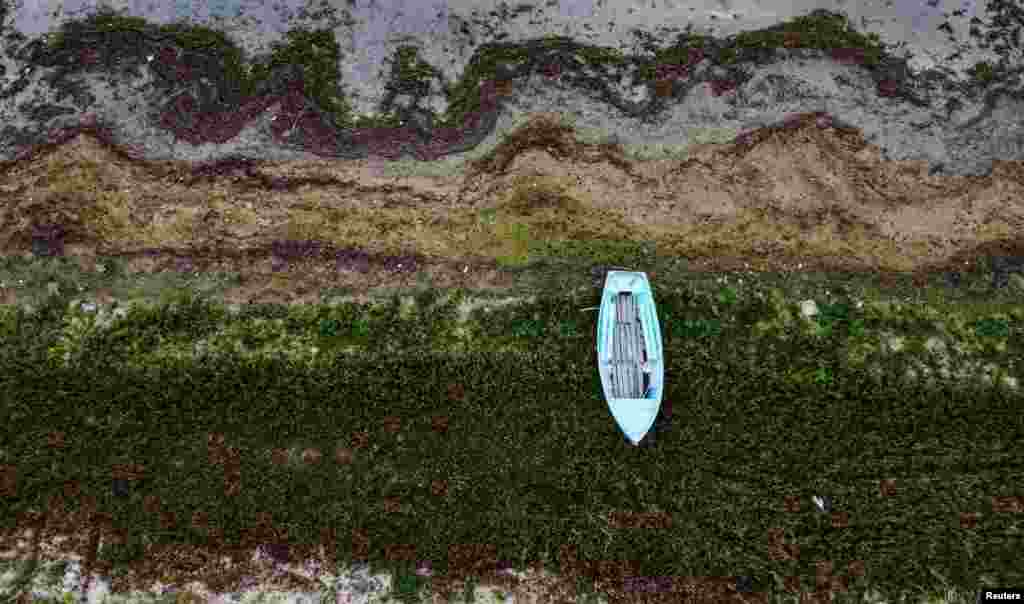 A rowing boat rest at last year's water line at Prespa lake in the village of Stenje, North Macedonia. Water levels at Prespa lake, located in North Macedonia, Greece and Albania have reached their lowest point in centuries following dry seasons. 