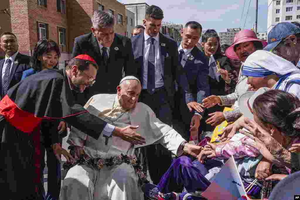 Pope Francis is greeted outside the Apostolic Prefecture in Ulaanbaatar's Kahn Uul district, in Mongolia.