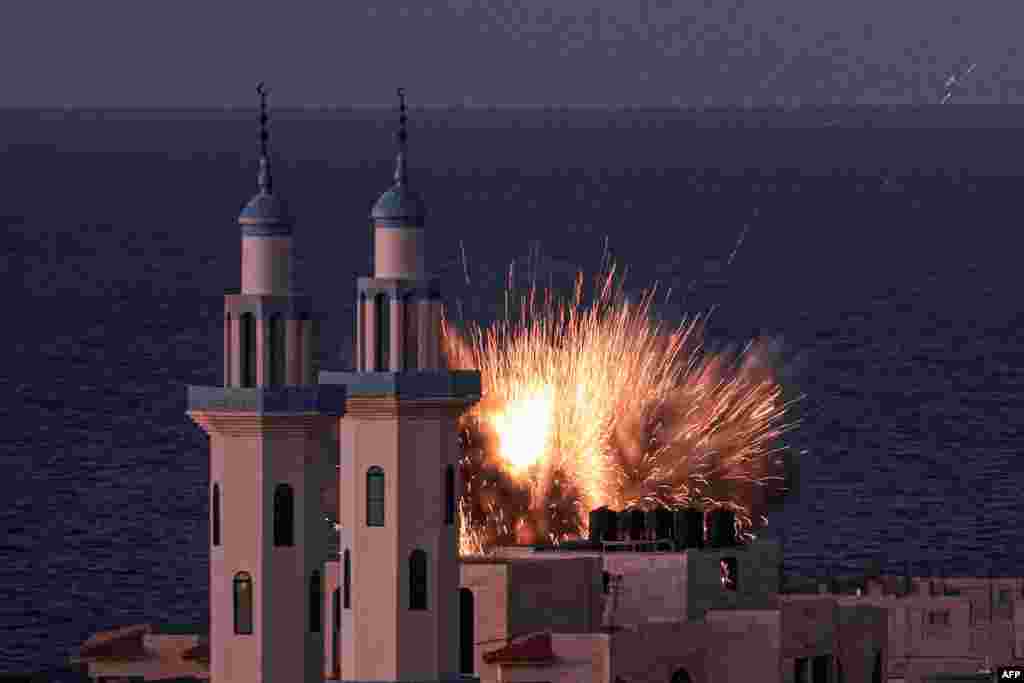 A fireball erupts from an Israeli airstrike in Gaza City.