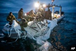Explosive Ordnance Disposal Group 2 recover a high-altitude surveillance balloon off the coast of Myrtle Beach, S.C., Feb. 5, 2023. (U.S. Navy via AP)
