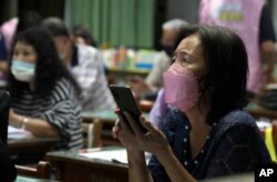 Students with Fake News Cleaner attend a class to learn how to use the LINE app in order to identify fake news, in Kaohsiung City, southern Taiwan, Thursday, March 16, 2023. (AP Photo/Chiang Ying-ying)
