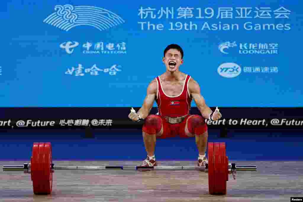 North Korea's Ri Wonju reacts at the 67Kg weightlifting Group A at the 19th Asian Games in Hangzhou, China.