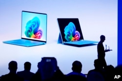 Brett Ostrum, Microsoft corporate vice president of Surface, shows a new Surface Laptop and Surface Pro with built-in AI during an event at Microsoft headquarter,s Monday, May 20, 2024, in Redmond, Wash. (AP Photo/Lindsey Wasson)