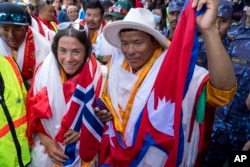 FILE - Norwegian climber Kristin Harila, left, and her Nepali sherpa guide Tenjen Sherpa, right, who climbed the world's 14 tallest mountains in record time, arrive in Kathmandu, Nepal, Aug. 5, 2023. (AP Photo/Niranjan Shrestha, File)