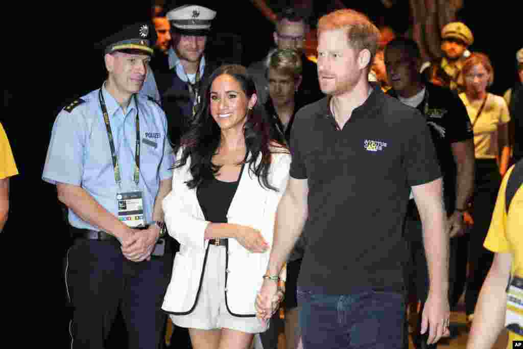 Britain's Prince Harry, right, and Meghan, Duchess of Sussex, arrive to a wheelchair basketball match at the Invictus Games in Duesseldorf, Germany.