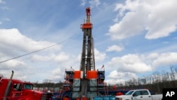 FILE - Work continues at a shale gas well drilling site in St. Mary's, Pa., March 12, 2020.(AP Photo/Keith Srakocic, File)