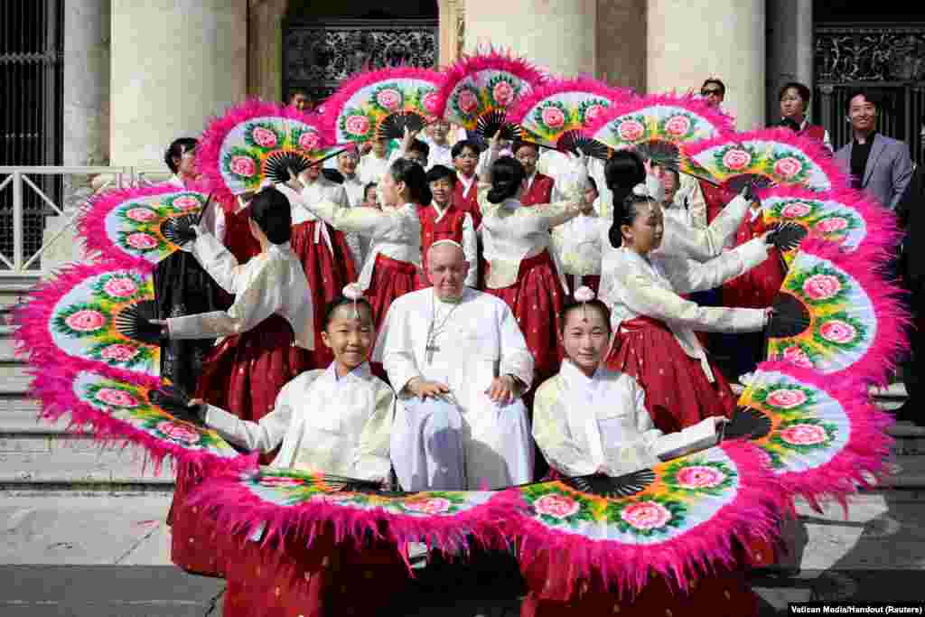 Pope Francis poses for a photo on the day of the weekly general audience at the Vatican.