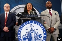 Fulton County District Attorney Fani Willis, center, speaks at the Fulton County Government Center during a news conference, in Atlanta, Georgia, Aug. 14, 2023. Donald Trump and several allies have been indicted in Georgia over efforts to overturn his 2020 election loss in the state. (AP Photo/John Bazemore)