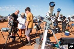 FILE - People prepare their viewing equipment in Exmouth, Australia, ahead of a solar eclipse, April 20, 2023. (Aaron Bunch/AAP Image via AP)