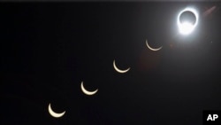 The progression of a total solar eclipse is seen with the moon passing in front of the sun above Siem Reap in northwestern Cambodia, on Tuesday, Oct. 24, 1995. (AP Photo/Richard Vogel, File)