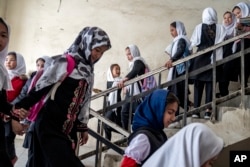 FILE - Girls attend school on the first day of the new school year, in Kabul, Afghanistan, on Saturday, March 25, 2023. (AP Photo/Ebrahim Noroozi)
