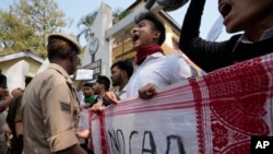 Police stop students trying take out a protest against the Citizenship Amendment Act (CAA) in Guwahati, India, Tuesday, March 12, 2024. (AP Photo/Anupam Nath)
