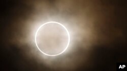 FILE - An annular eclipse at a waterfront park in Yokohama, near Tokyo, Monday, May 21, 2012. (AP Photo/Shuji Kajiyama)