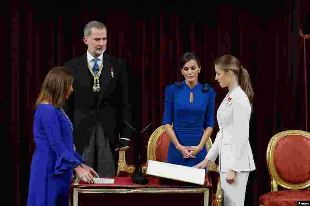 Spain's Princess Leonor swears an oath to the constitution on her 18th birthday as her parents Spain's King Felipe, Queen Letizia look at her at the parliament in Madrid.