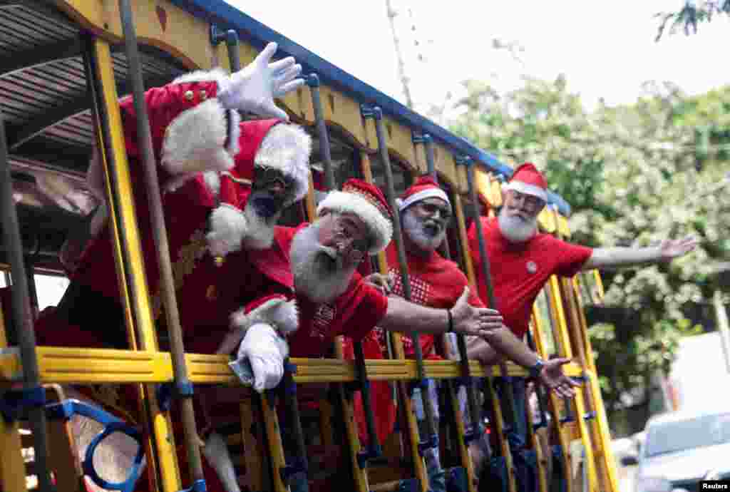 Brazil's Santa Claus school members travel on a Bonde (tram) as they take part in their graduation, ahead of the Christmas season in Rio de Janeiro, Brazil.