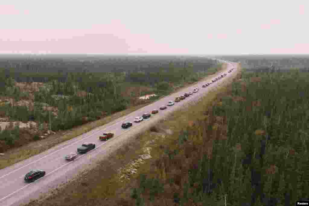 Yellowknife residents leave the city on Highway 3, the only highway in or out of the community, after an evacuation order was given due to the proximity of a wildfire in Yellowknife, Northwest Territories, Canada, Aug. 16, 2023.