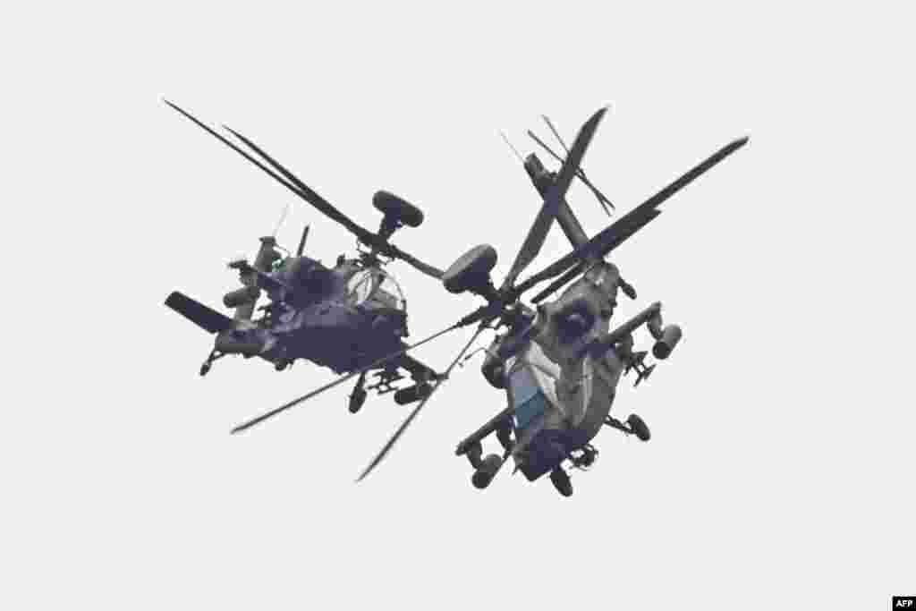 Two U.S.-made Apache attack helicopters, from Taiwan's Army Airborne Special Forces, demonstrate their combat skills during a military open house event in Hsinchu, Taiwan.