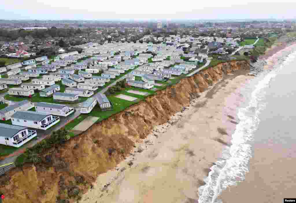 View of the seafront and collapsed road following the erosion caused by high tides and wind at Parkfield Holiday Park in Lowestoft, Britain.