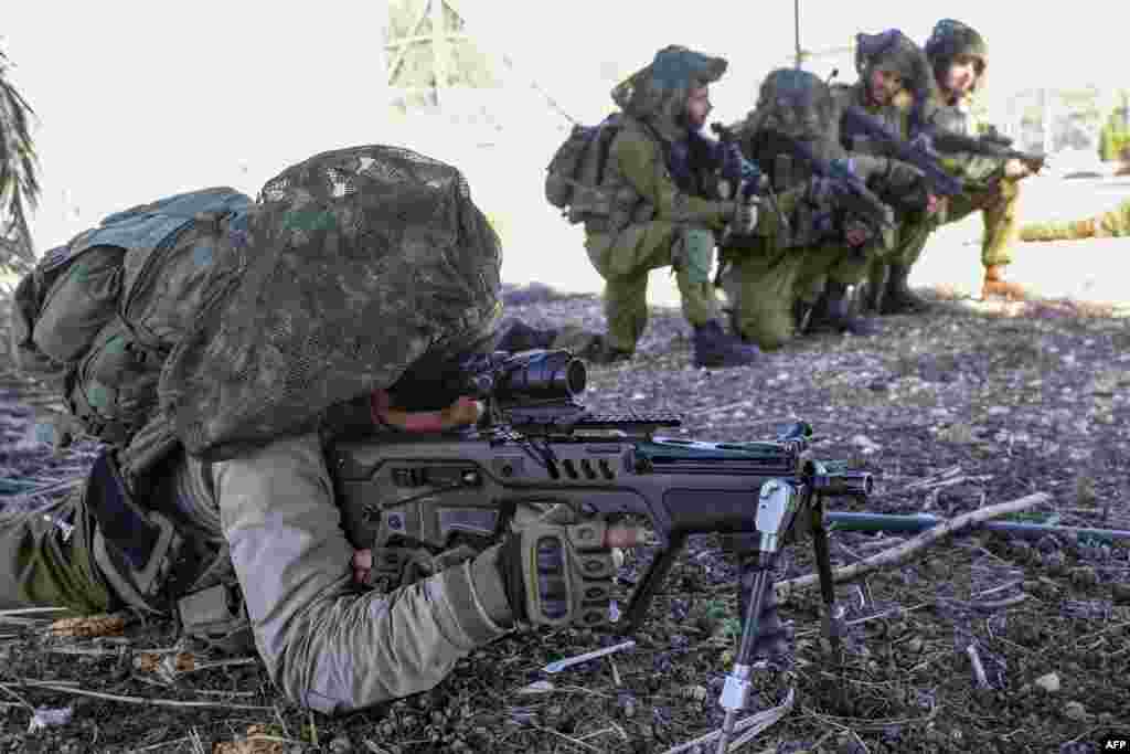 Israeli soldiers keep a position while troops train in the upper Galilee region of northern Israel near the border with Lebanon, amid increasing cross-border tensions between Hezbollah and Israel as fighting continues in the south with Hamas militants in the Gaza Strip. 