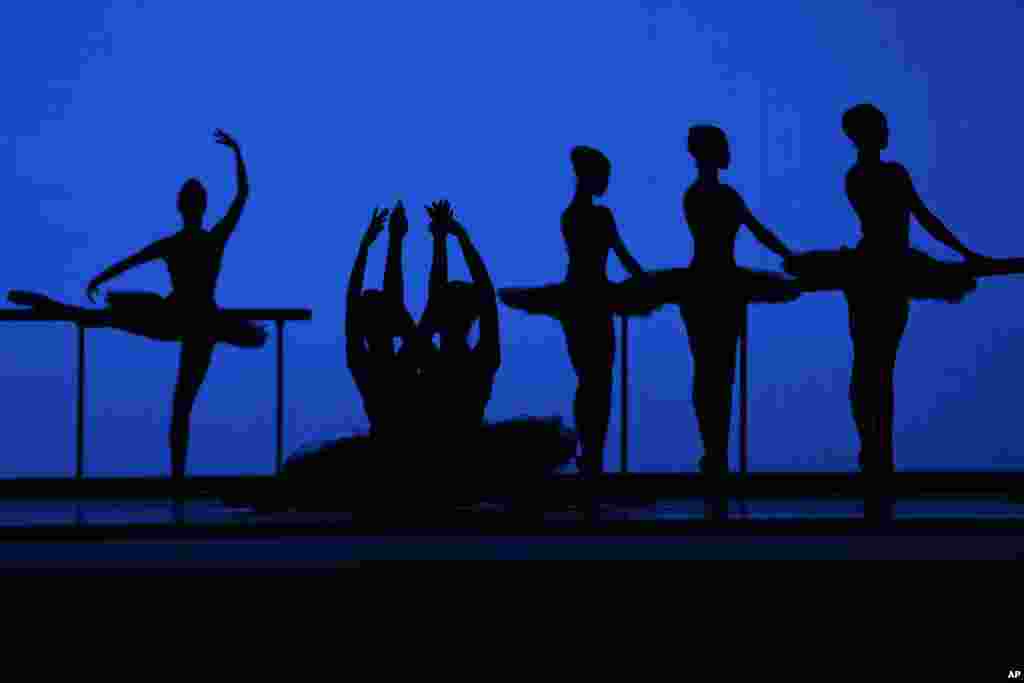 American Ballet Theater's dancers are silhouetted as they rehearse for the opening night at the Shanghai Grand Theater in Shanghai, China.