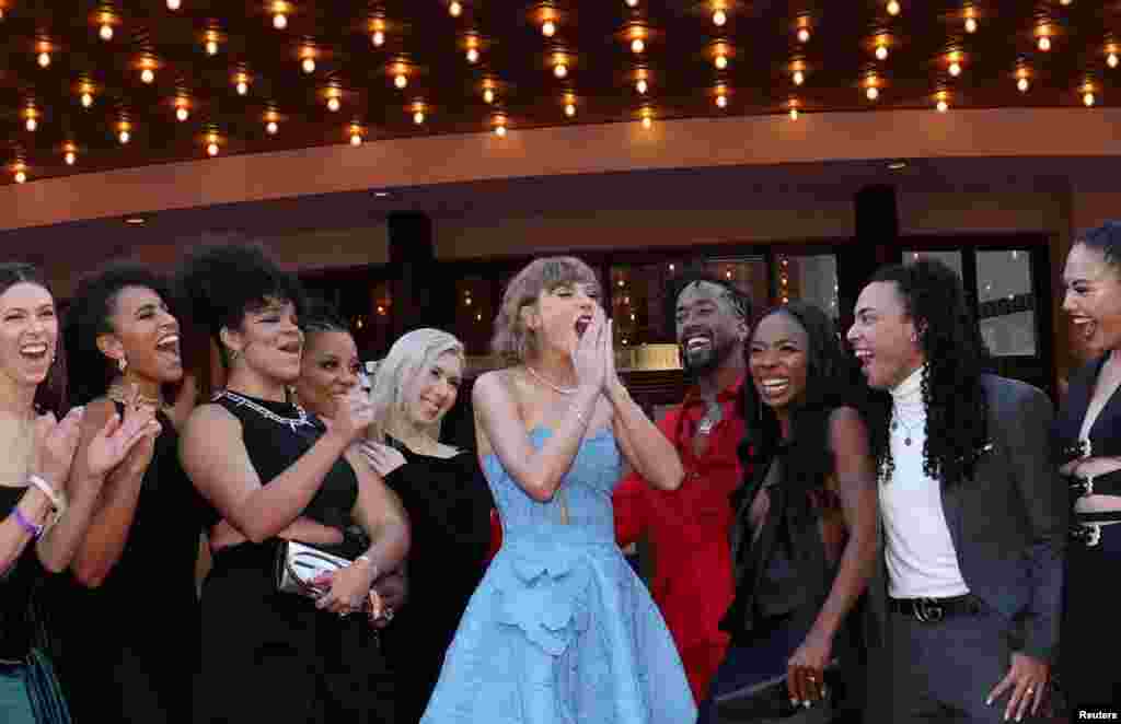 Taylor Swift, along with dancers and the band, attends a premiere for Taylor Swift: The Eras Tour in Los Angeles, California, Oct. 11, 2023.