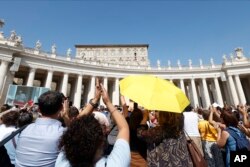 Faithful gathered for the traditional Sunday noon blessing in St. Peter's Square at The Vatican cheers at Pope Francis appearing at his studio's window, Sunday, Oct. 1, 2023. (AP Photo/Riccardo De Luca)