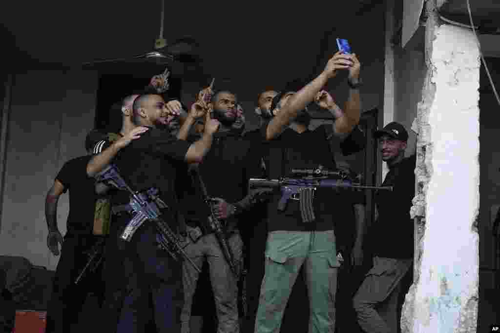 Palestinian militants take a selfie in a destroyed building after an Israeli military raid on the town of Tulkarem, West Bank.