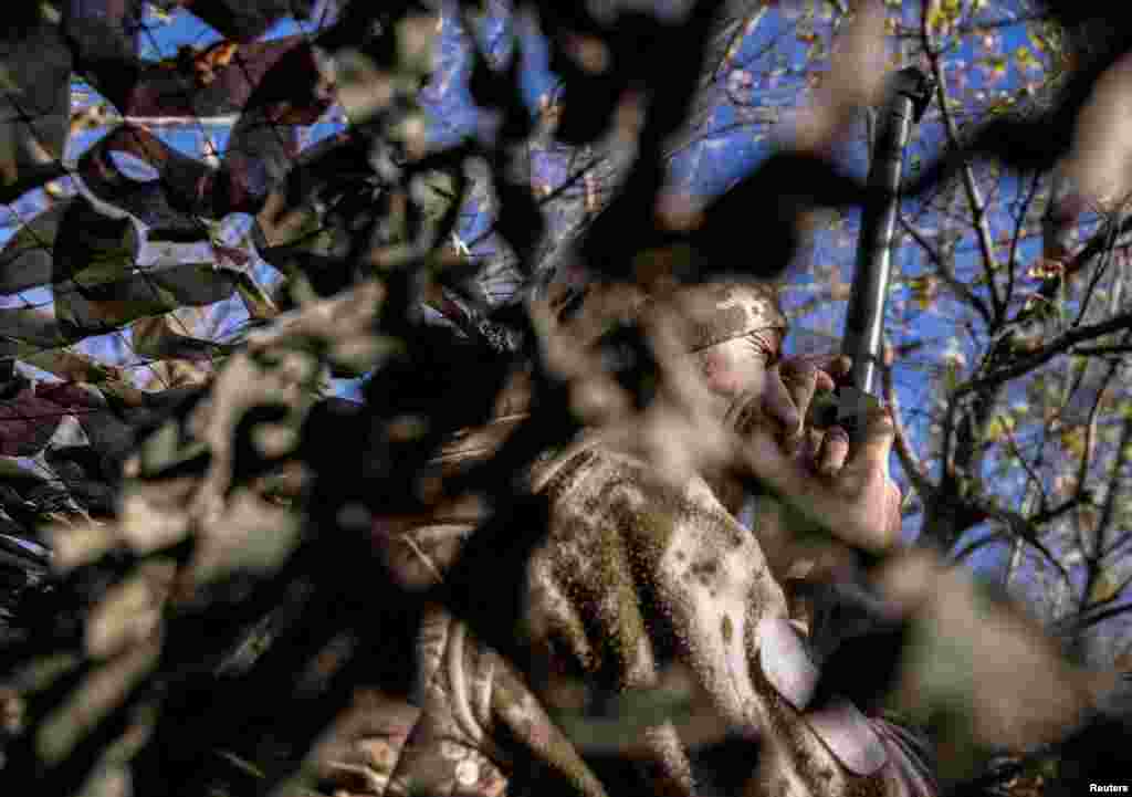 A Ukrainian serviceman observes an area at a position near a frontline, amid Russia's attack on Ukraine, in Donetsk region, Oct. 15, 2023.