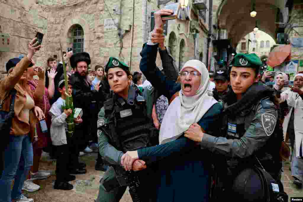 Israeli border police officers detain a Palestinian protester during the Jewish holiday of Sukkot in Jerusalem's Old City.
