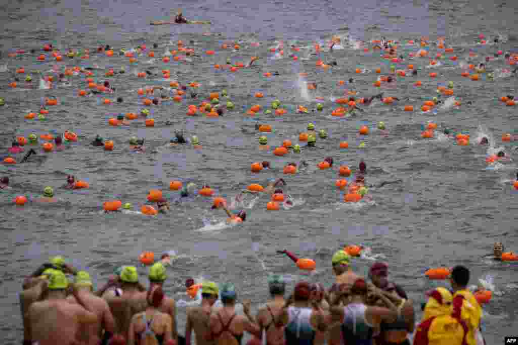 Participants take part in the Harbour Race, where swimmers cross Hong Kong's Victoria Harbour, in the city.