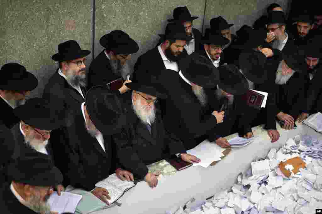 Chabad-Lubavitch rabbis pray for the people of Israel, Jews everywhere and all of humanity at the resting place of the Rabbe, Rabbi Menachem Mendel Schneerson at Montefiore Cemetery in the Queens borough of New York.