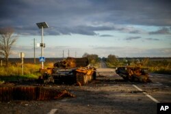 Remains of a destroyed Russian tank are scattered on the ground along the road between Izium and Kharkiv, Ukraine, Monday, Oct. 3, 2022. (AP Photo/Francisco Seco)