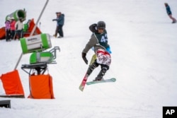 Sekholo Ramonotsi, 13, competes in the Winter Whip Slopestyle snowboard and ski competition at the Afriski ski resort near Butha-Buthe, Lesotho, Saturday July 30, 2022. (AP Photo/Jerome Delay)
