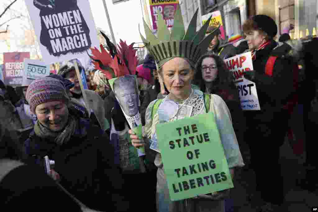 Demonstrators take part in the Women's March on London, following the Inauguration of U.S. President Donald Trump, in London, Jan. 21, 2016. (AP Photo/Tim Ireland)