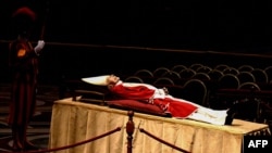 The body of Pope Emeritus Benedict XVI lays in state at St. Peter's Basilica in the Vatican, on January 2, 2023. (Photo by Tiziana FABI / AFP)