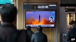 资料图：韩国民众在首尔火车站观看朝鲜发射导弹的电视新闻。（路透社2022年3月16日）