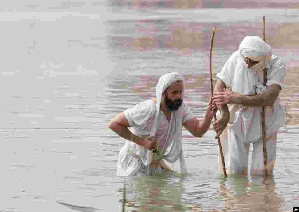 Followers of the Sabean Mandaeans faith, a pre-Christian sect that follows the teachings of the Bible's John the Baptist, perform their rituals in the Tigris River during a celebration marking "Banja" or Creation Feast, in central Baghdad, Iraq.