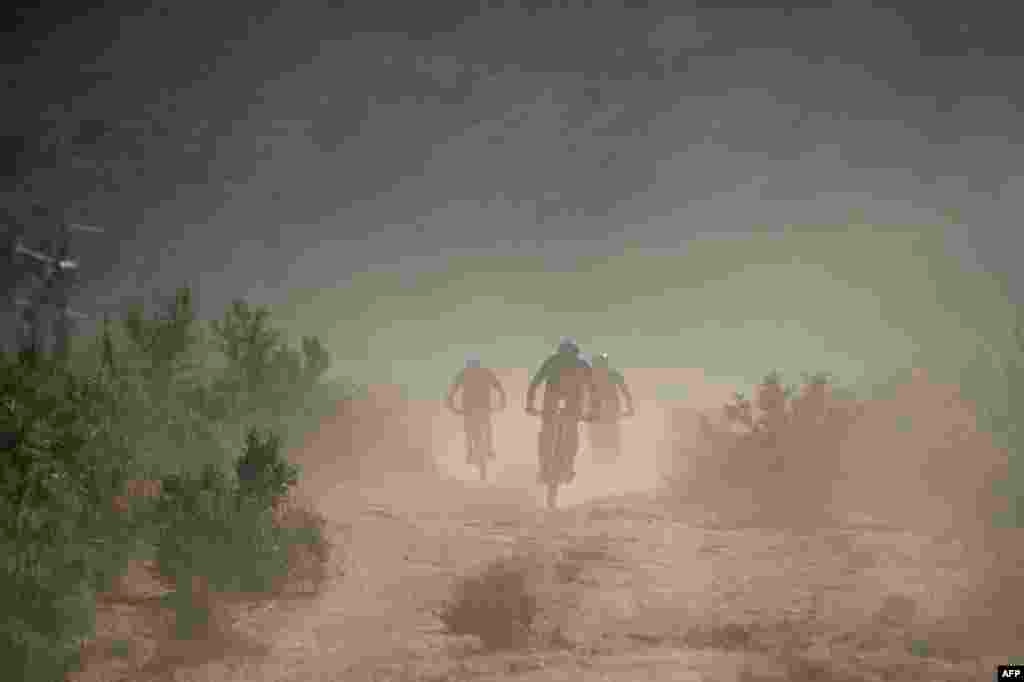 Riders cycle on dusty trails during the first stage of the 2022 Cape Epic mountain bike stage race in the mountains above Somerset West, about 60km from Cape Town, South Africa.
