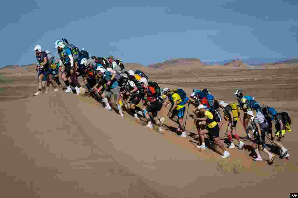 Competitors take part in the Stage 2 of the 36th edition of the Marathon des Sables between Ouest Aguenoun n'Oumerhiout and Rich Mbirika in the Moroccan Sahara desert, central Morocco.